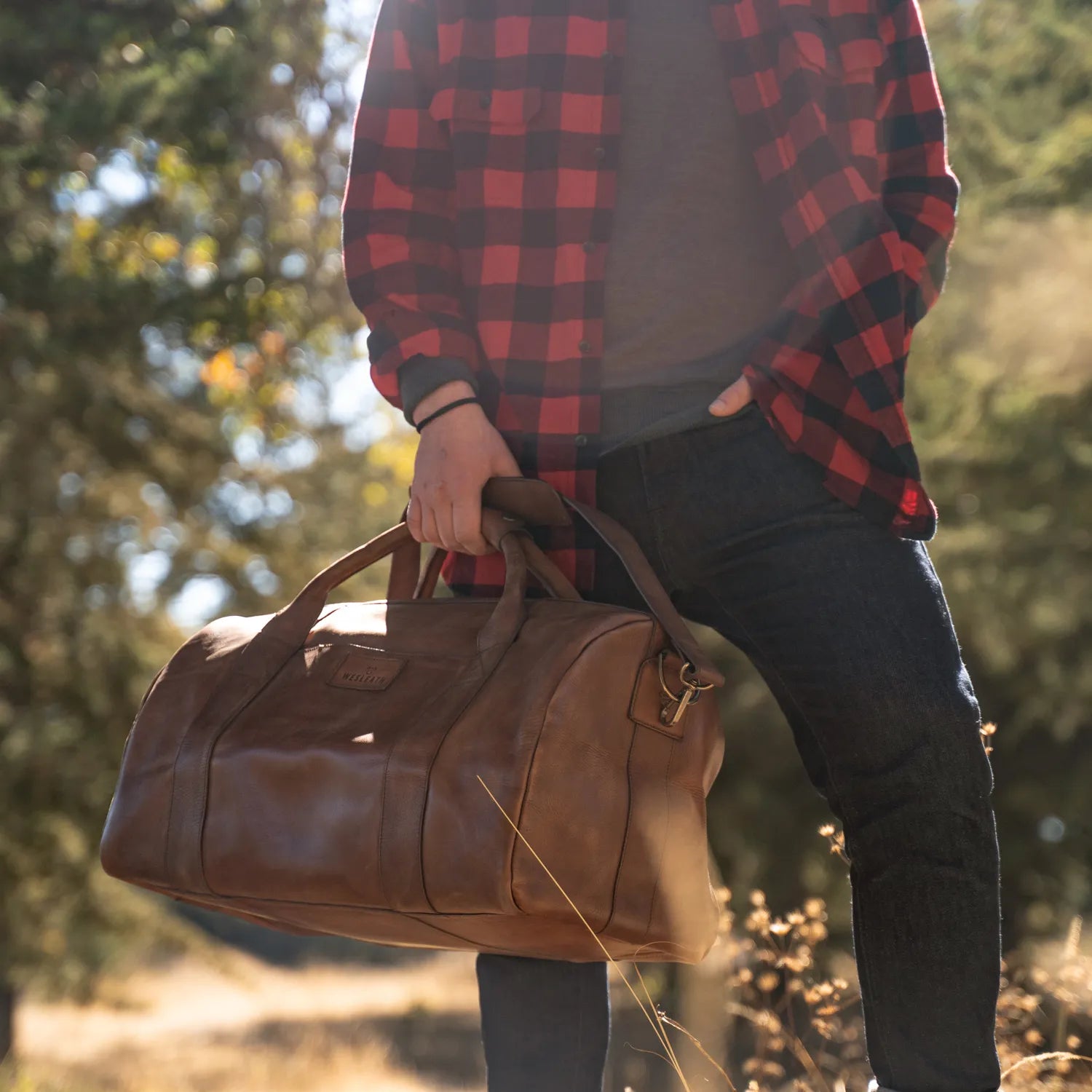 Man on the forest taking Wesleath duffle bag